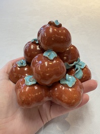 A pair of Chinese polychrome 'persimmons' groups on wooden stands, 19th C.