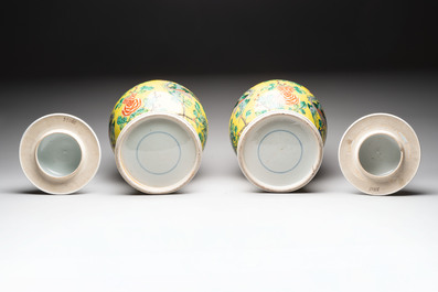 A pair of Chinese famille verte yellow-ground 'pheasants and peonies' vases and covers, 19th C.