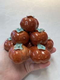 A pair of Chinese polychrome 'persimmons' groups on wooden stands, 19th C.