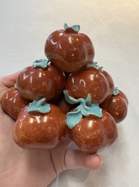 A pair of Chinese polychrome 'persimmons' groups on wooden stands, 19th C.