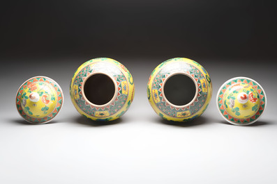 A pair of Chinese famille verte yellow-ground 'pheasants and peonies' vases and covers, 19th C.