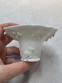 A Chinese Dehua blanc de Chine libation cup, a famille rose cup and two figures, 19th C.