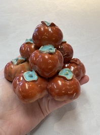 A pair of Chinese polychrome 'persimmons' groups on wooden stands, 19th C.