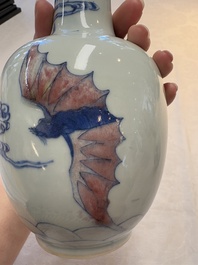 A pair of Chinese blue, white and copper-red 'bats among the clouds' vases, 19th C.