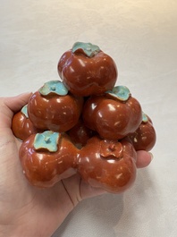 A pair of Chinese polychrome 'persimmons' groups on wooden stands, 19th C.