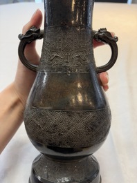 A fine Chinese archaistic bronze 'hu' vase with dragon handles, Yuan