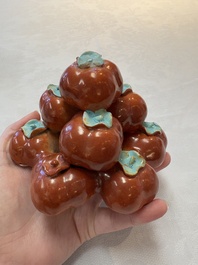 A pair of Chinese polychrome 'persimmons' groups on wooden stands, 19th C.