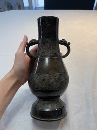 A fine Chinese archaistic bronze 'hu' vase with dragon handles, Yuan