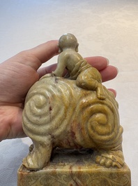A Chinese soapstone carving of a boy riding an elephant, 20th C.