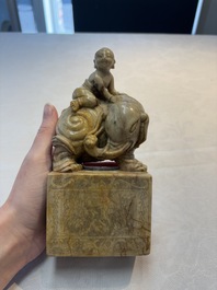 A Chinese soapstone carving of a boy riding an elephant, 20th C.
