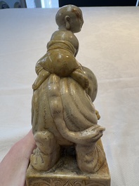 A Chinese soapstone carving of a boy riding an elephant, 20th C.