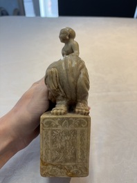 A Chinese soapstone carving of a boy riding an elephant, 20th C.