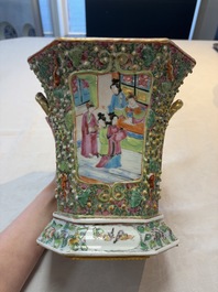 A pair of Chinese Canton famille rose flower holders and covers with figural design, 19th C.