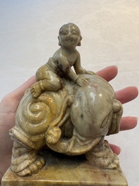 A Chinese soapstone carving of a boy riding an elephant, 20th C.