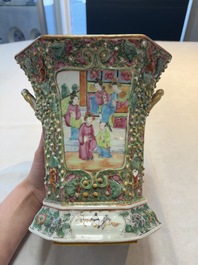 A pair of Chinese Canton famille rose flower holders and covers with figural design, 19th C.