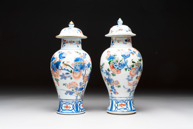 A pair of Chinese verte-Imari 'birds among flowering branches' vases and covers, Kangxi