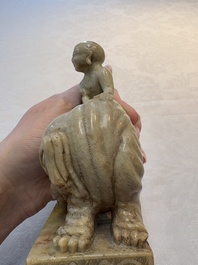 A Chinese soapstone carving of a boy riding an elephant, 20th C.