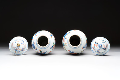 A pair of Chinese verte-Imari 'birds among flowering branches' vases and covers, Kangxi
