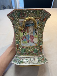 A pair of Chinese Canton famille rose flower holders and covers with figural design, 19th C.