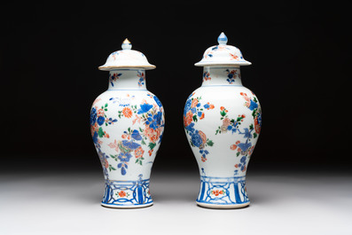 A pair of Chinese verte-Imari 'birds among flowering branches' vases and covers, Kangxi