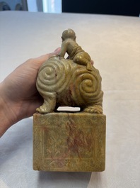 A Chinese soapstone carving of a boy riding an elephant, 20th C.