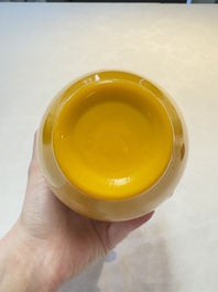 A Chinese Peking yellow glass vase on wooden stand, 19th C.