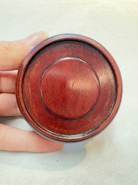A Chinese Peking yellow glass vase on wooden stand, 19th C.