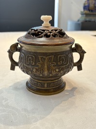 A Chinese archaistic bronze censer with a wooden cover, Xuande mark, 19th C.