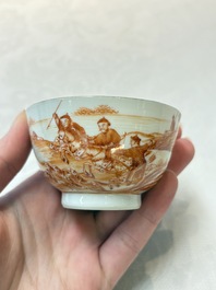 A pair of Chinese iron-red-decorated 'deer hunting' cups and saucers, Qianlong
