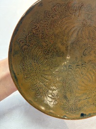 A Chinese Ding-type persimmon-glazed bowl with incised floral design, possibly Song