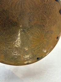 A Chinese Ding-type persimmon-glazed bowl with incised floral design, possibly Song