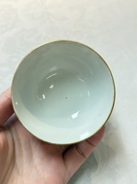 A pair of Chinese iron-red-decorated 'deer hunting' cups and saucers, Qianlong