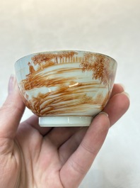 A pair of Chinese iron-red-decorated 'deer hunting' cups and saucers, Qianlong