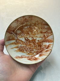 A pair of Chinese iron-red-decorated 'deer hunting' cups and saucers, Qianlong