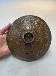 A Chinese Ding-type persimmon-glazed bowl with incised floral design, possibly Song