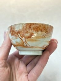 A pair of Chinese iron-red-decorated 'deer hunting' cups and saucers, Qianlong
