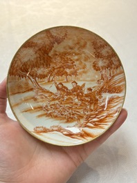A pair of Chinese iron-red-decorated 'deer hunting' cups and saucers, Qianlong