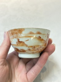 A pair of Chinese iron-red-decorated 'deer hunting' cups and saucers, Qianlong