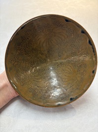 A Chinese Ding-type persimmon-glazed bowl with incised floral design, possibly Song