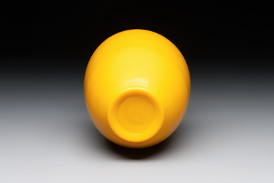 A Chinese Peking yellow glass vase on wooden stand, 19th C.