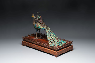 A large Chinese precious stone-inset and enamelled gilt-silver filigree peacock and flower basket on a wooden stand, Republic