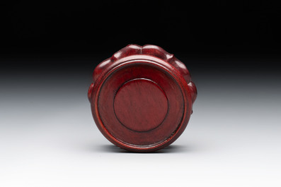 A Chinese Peking yellow glass vase on wooden stand, 19th C.