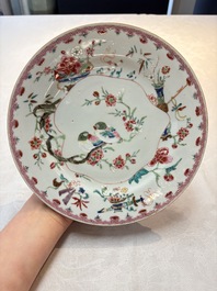 Three Chinese famille rose plates with birds among flowers and a grisaille plate, Yongzheng/Qianlong