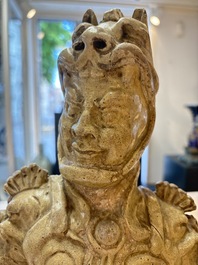 A Chinese stoneware cream-glazed sculpture of a warrior, possibly Tang