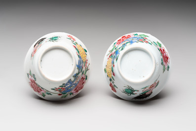 A Chinese famille rose 'roosters' covered teapot and two cups and saucers, Yongzheng