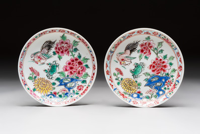 A Chinese famille rose 'roosters' covered teapot and two cups and saucers, Yongzheng