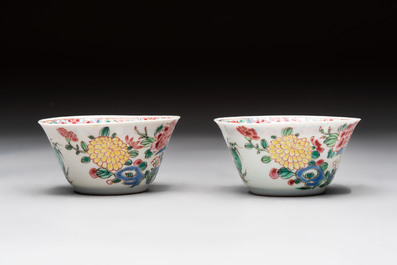 A Chinese famille rose 'roosters' covered teapot and two cups and saucers, Yongzheng
