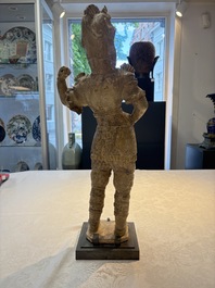 A Chinese stoneware cream-glazed sculpture of a warrior, possibly Tang