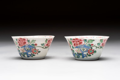 A Chinese famille rose 'roosters' covered teapot and two cups and saucers, Yongzheng
