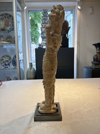 A Chinese stoneware cream-glazed sculpture of a warrior, possibly Tang